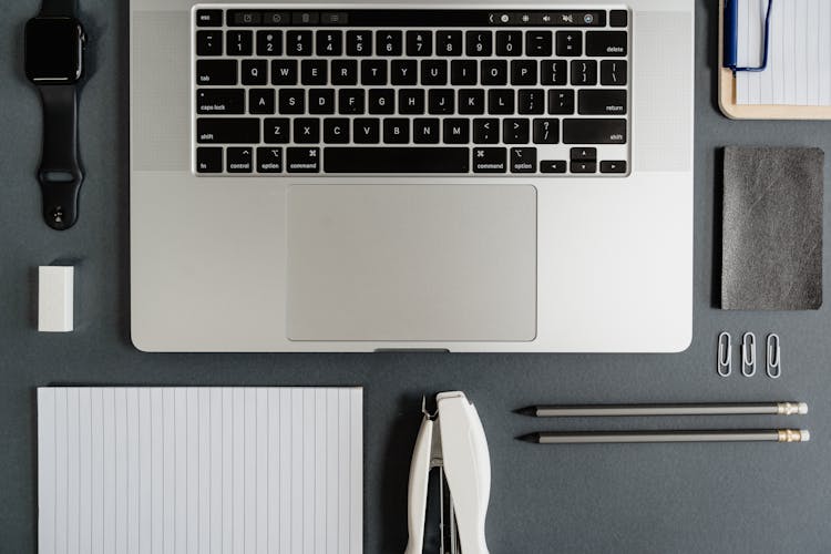 Laptop And Stationery On Black Background