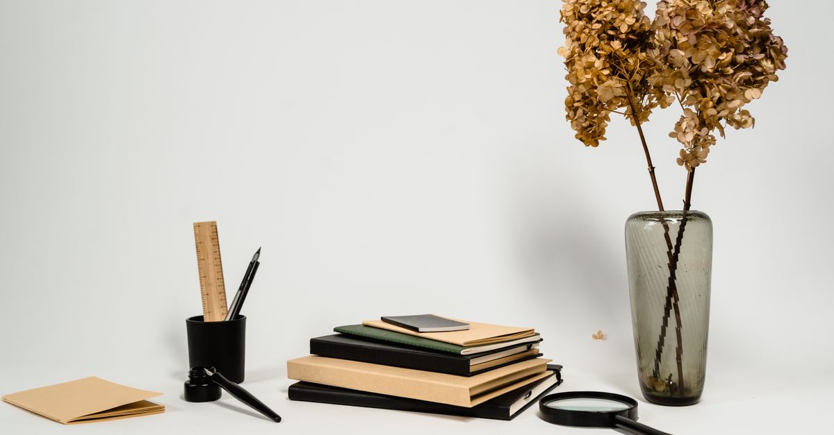 minimalistic workspace with a single notebook and pen, clean desk aesthetic