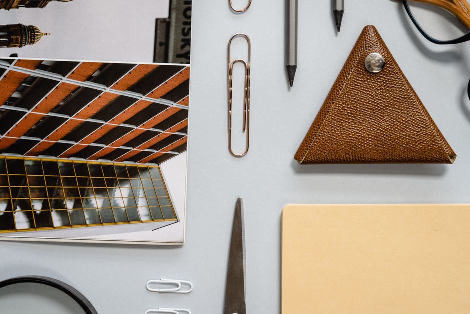 Top view of stationery items and architectural photo on a white background for office or school use. Top view of stationery items and architectural photo on a white background for office or school use.