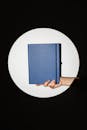 A Person Holding a Notebook