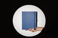 A Person Holding a Notebook