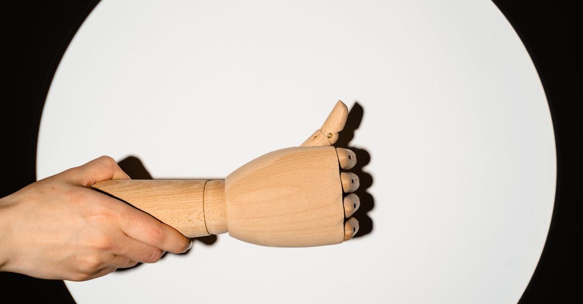 UCL Tear in Thumb: From Diagnosis to Recovery Guide 2026 1 A wooden hand model showing a thumbs-up gesture against a white circular background. - ucl tear in thumb