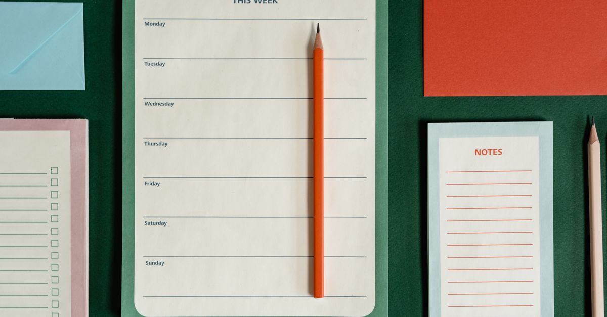 a weekly planner spread on a desk, with a red highlighter marking a "Do Not Disturb" block