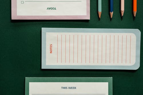 Notepads Beside Sharpened Pencils