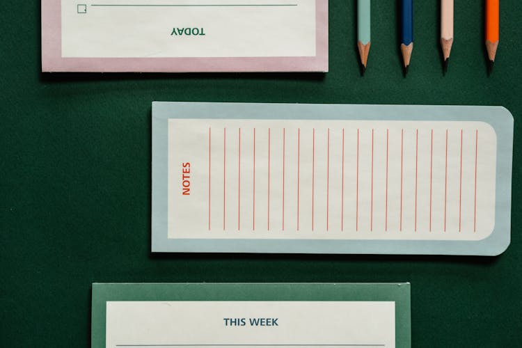 Notepads Beside Sharpened Pencils