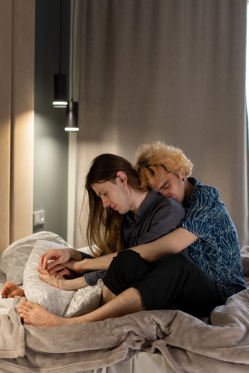 Free Couple embracing tenderly in a serene bedroom, showcasing love and intimacy. Stock Photo