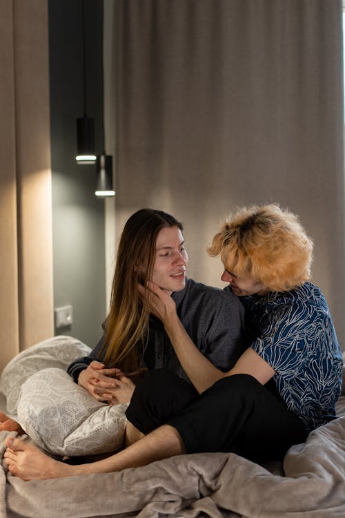 Free Couple Sitting on Bed Stock Photo