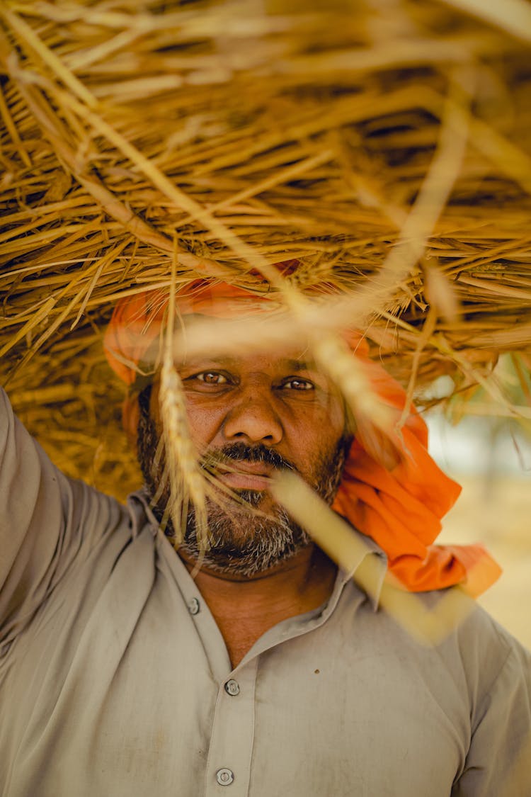 Bearded Man Carrying Hay On His Head