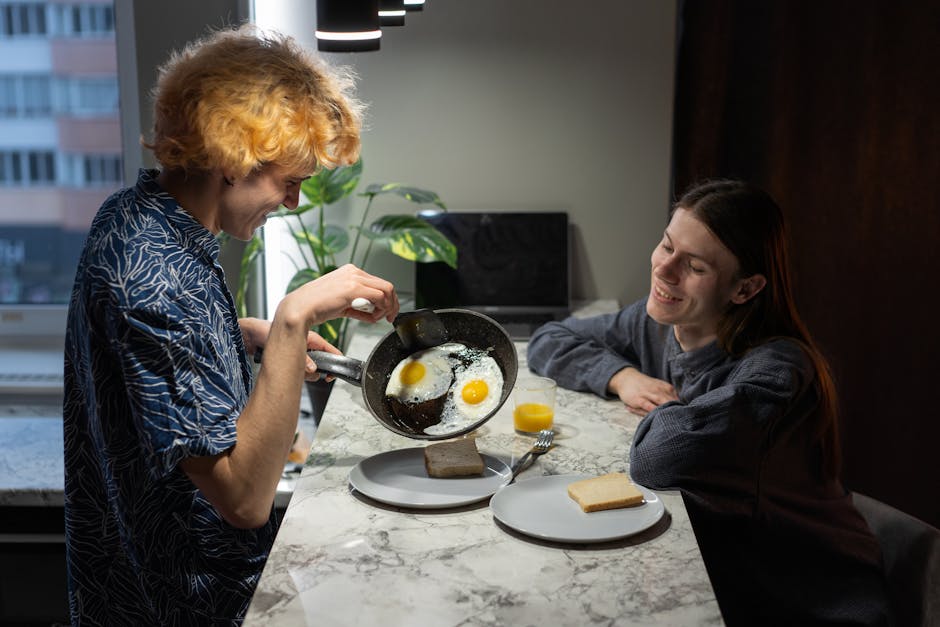 Carbon Steel vs Cast Iron: High-Heat Cooking Showdown A happy couple preparing and enjoying a breakfast of eggs and toast in a cozy kitchen setting.