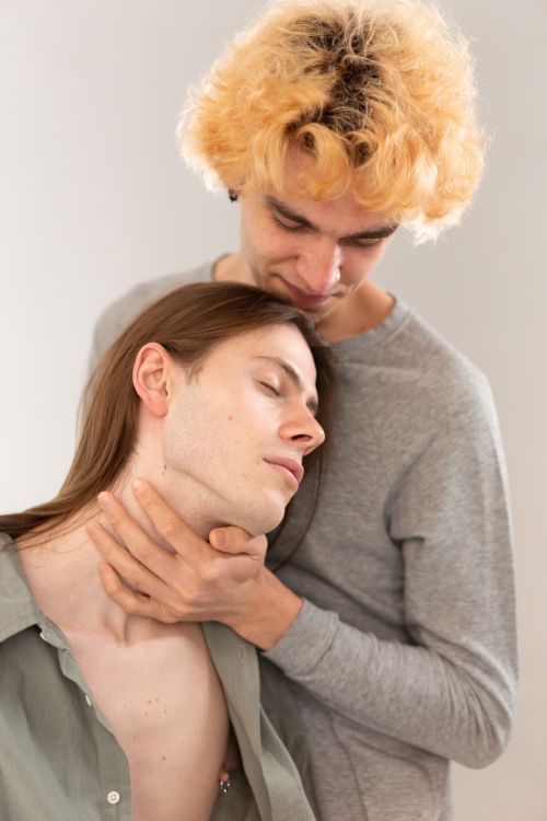 Free Close-up of a loving embrace between two young men indoors. Stock Photo