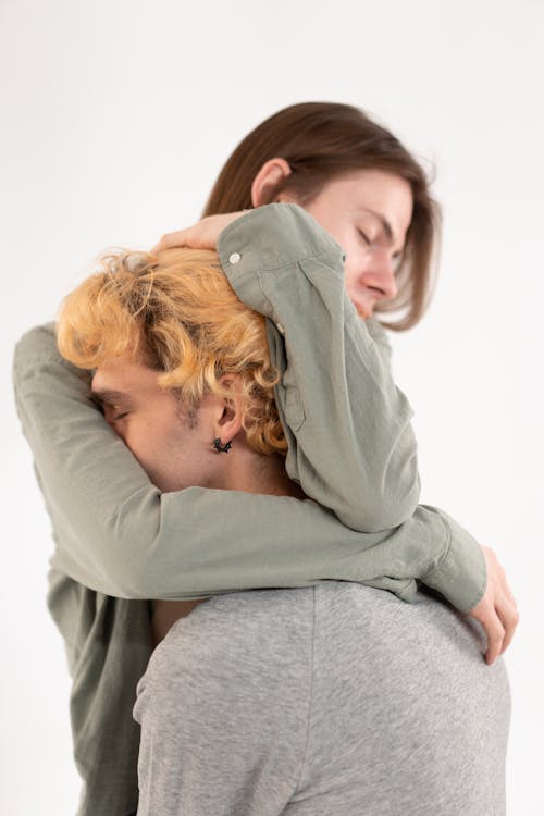 Free Man Hugging Another Man in Gray Sweater Stock Photo