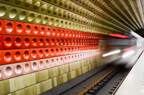 Blurred Metro Train and Colorful Wall