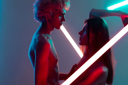 Free Topless Men Standing in Between Neon Lights Stock Photo