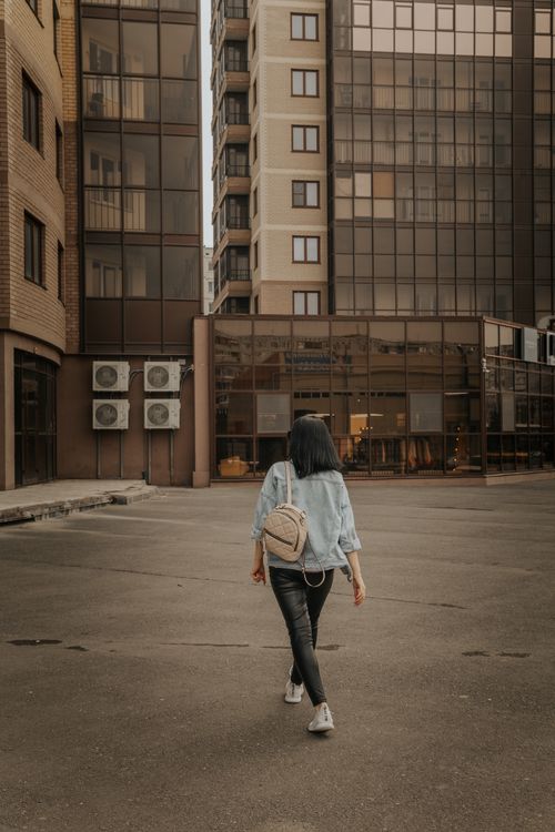 Unrecognizable stylish woman walking in street in city · Free Stock Photo
