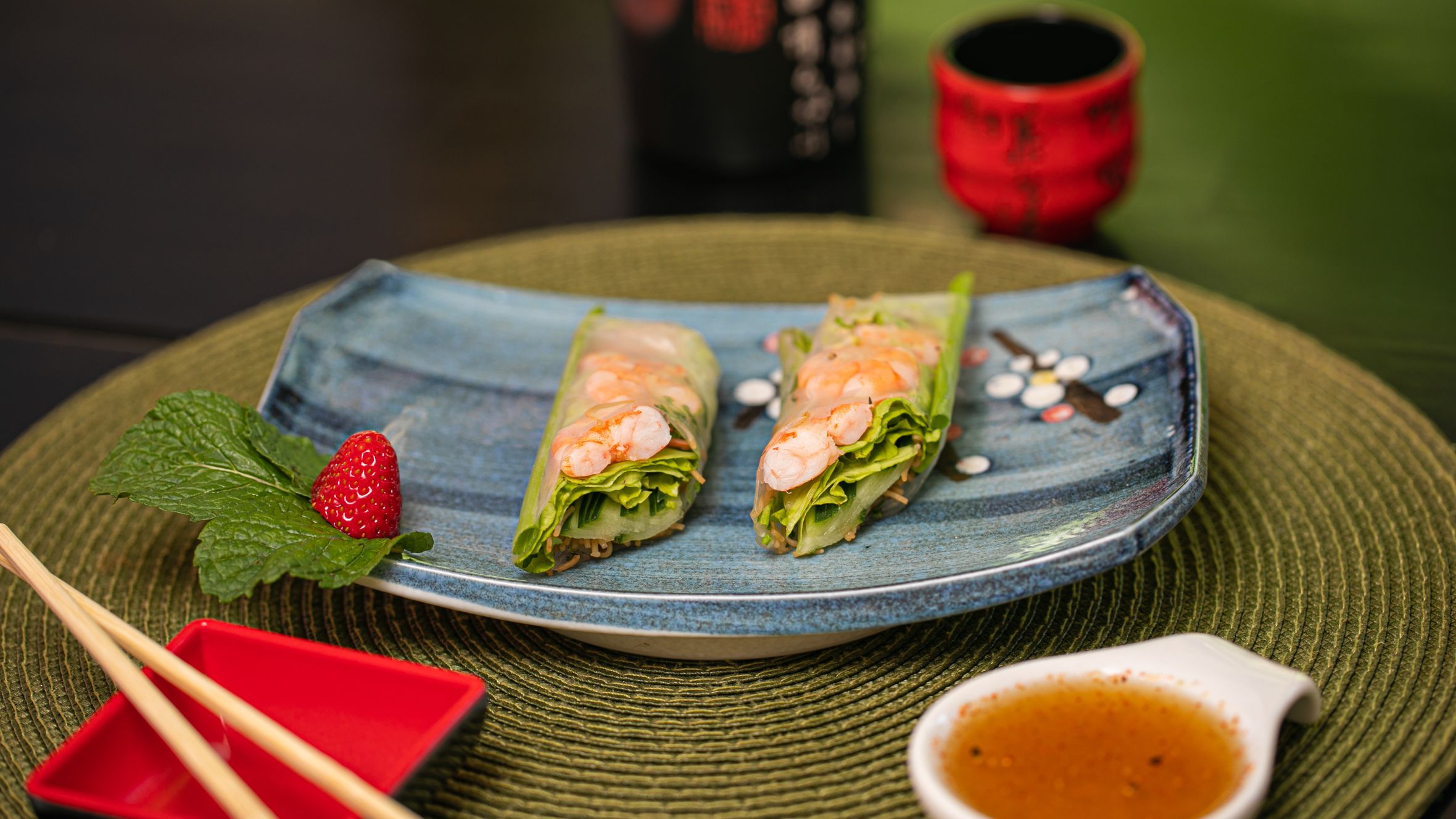Delicious Vietnamese spring rolls served on a ceramic plate with dipping sauce.