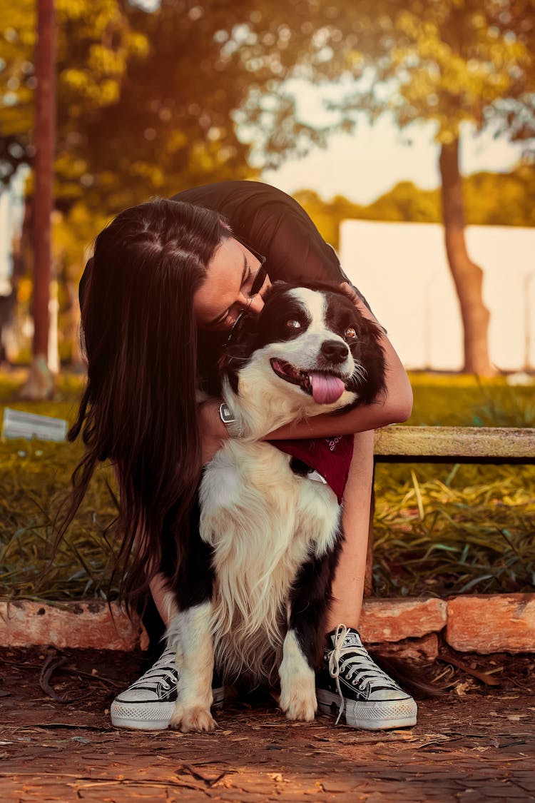 A Woman Hugging Her Dog