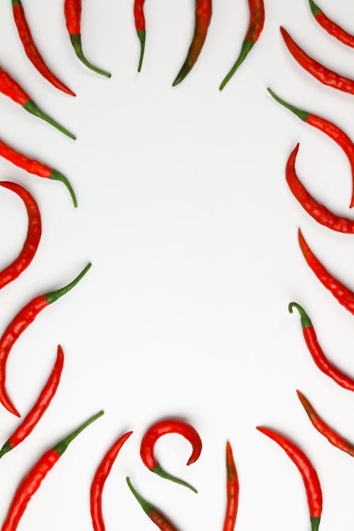 Photo of Red Chili Peppers on a White Surface