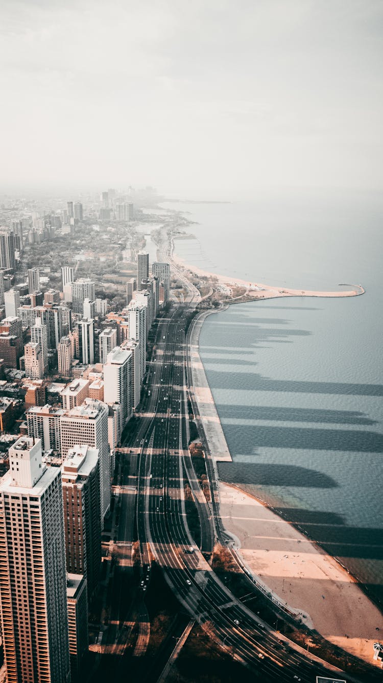 Aerial View Of City Buildings Near Body Of Water