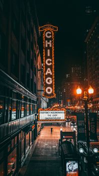 A vibrant capture of Chicago Theater with illuminated signage in downtown at night.