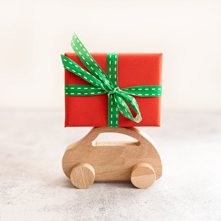 Gift Box On Top Of A Wooden Toy Car