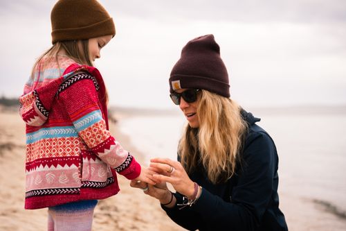 Free A mother and her daughter share a joyful moment on a beach in Petoskey, Michigan. Stock Photo