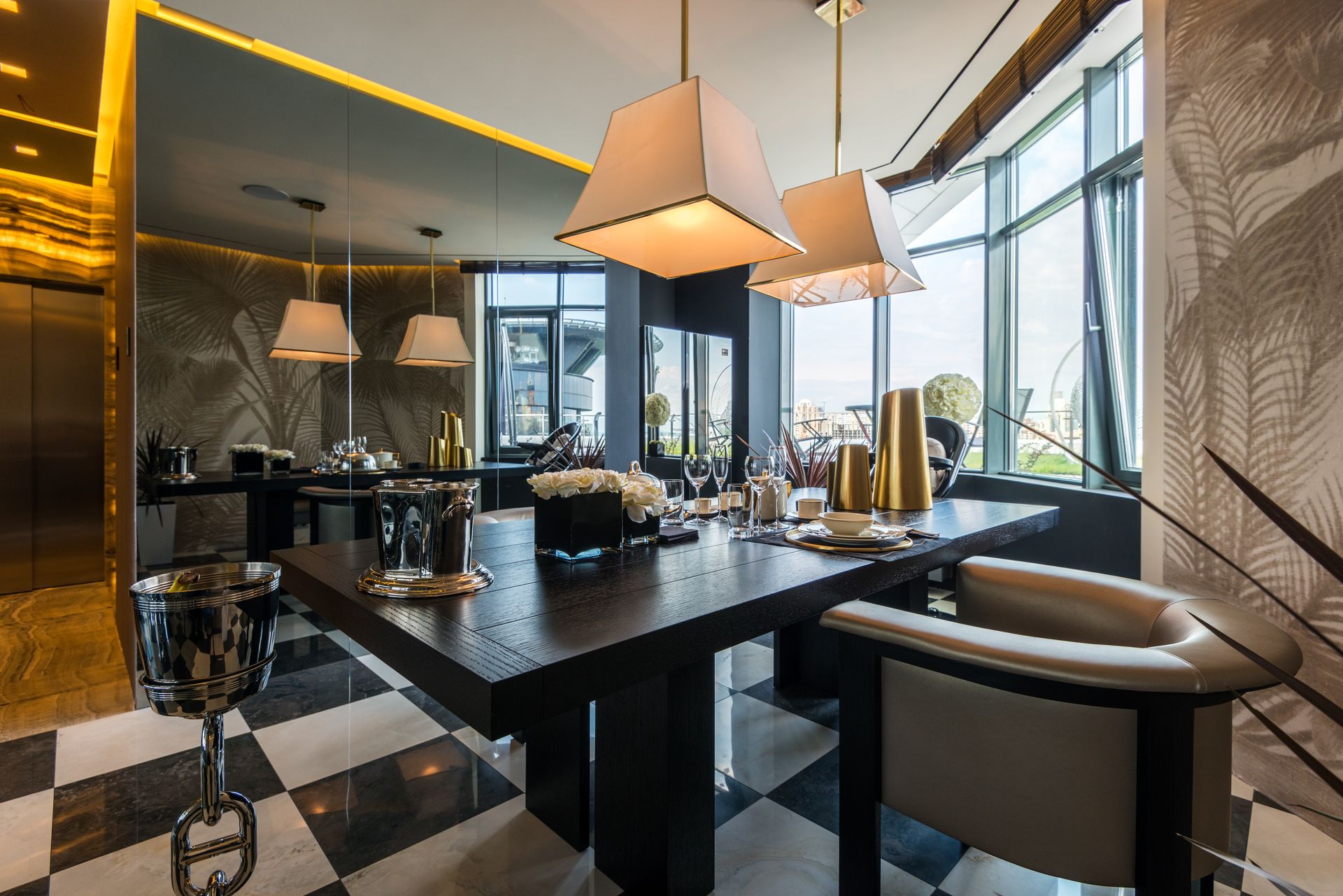 Modern dining room featuring elegant furniture, pendant lights, and large windows with city views.