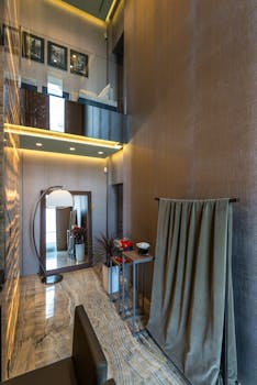 Double-height modern apartment with elegant decor and natural lighting.