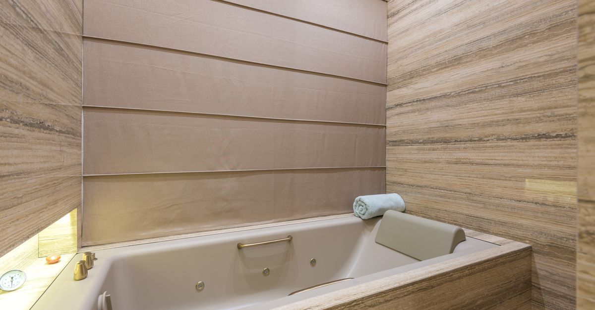 Luxurious modern bathroom interior featuring a marble bathtub and elegant design.