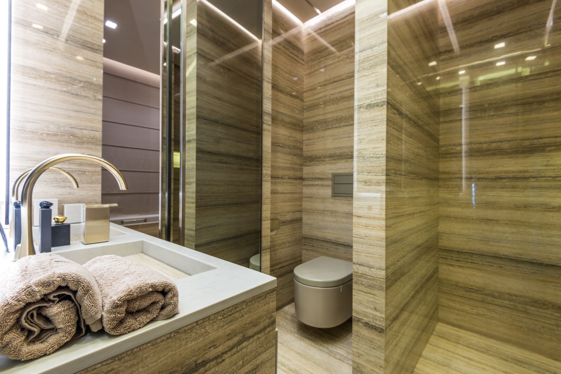 Refined luxury bathroom sink with polished stone and coordinated fixtures