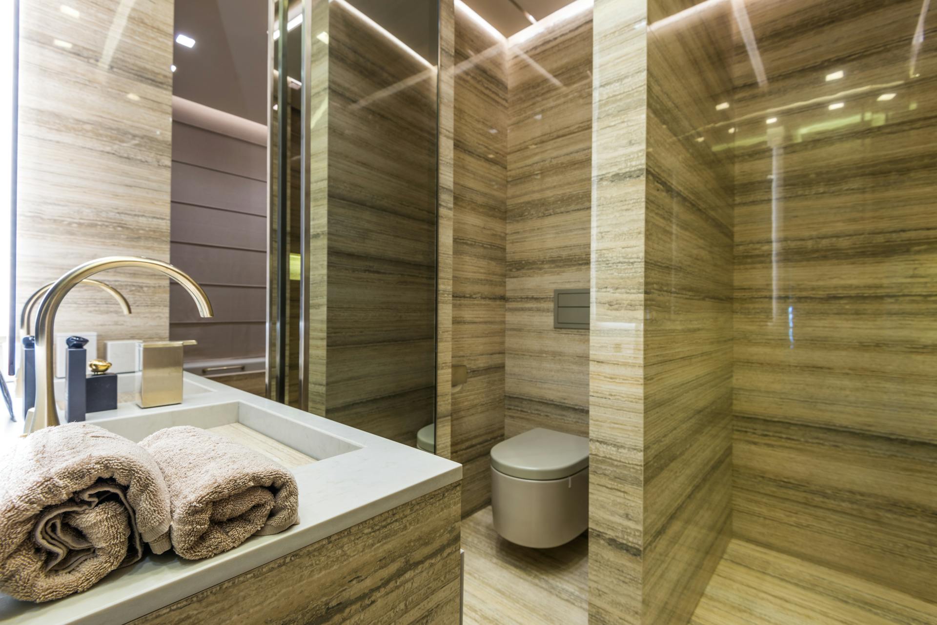 Elegant and luxurious bathroom interior with marble walls and sleek fixtures.