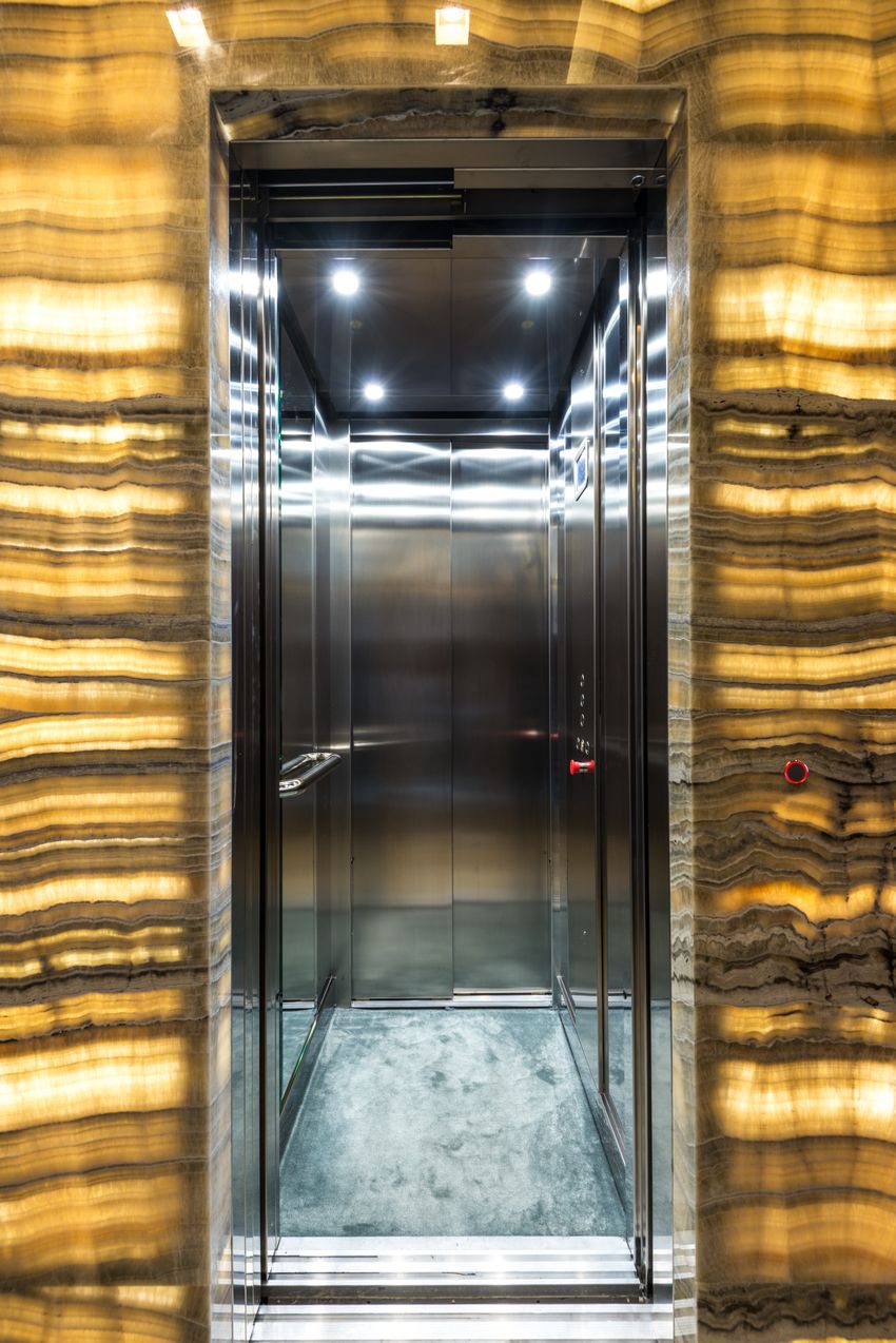 Stainless steel lift cabin interior with decorative wall cladding