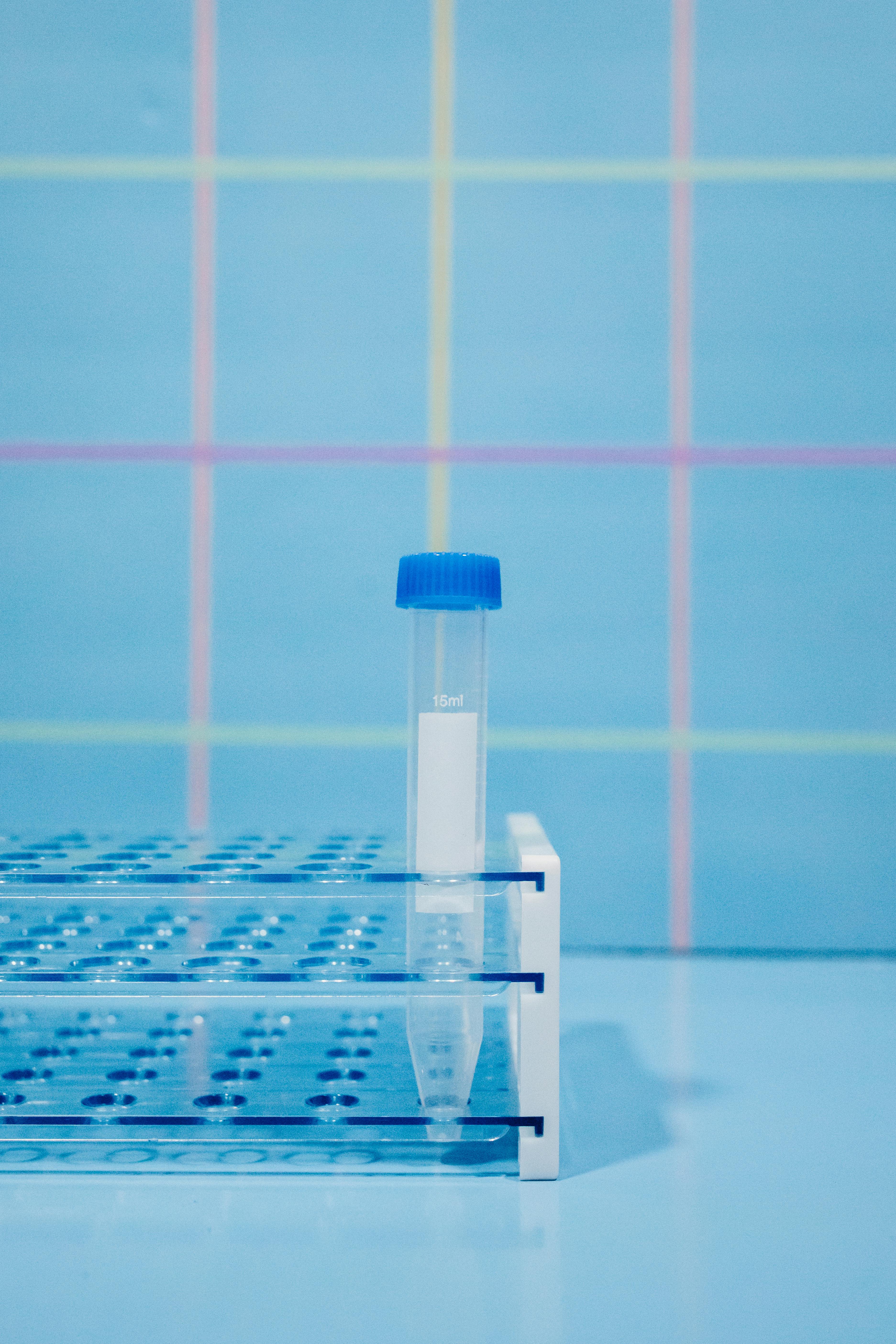 A Blue Cap Test Tube in a Rack · Free Stock Photo