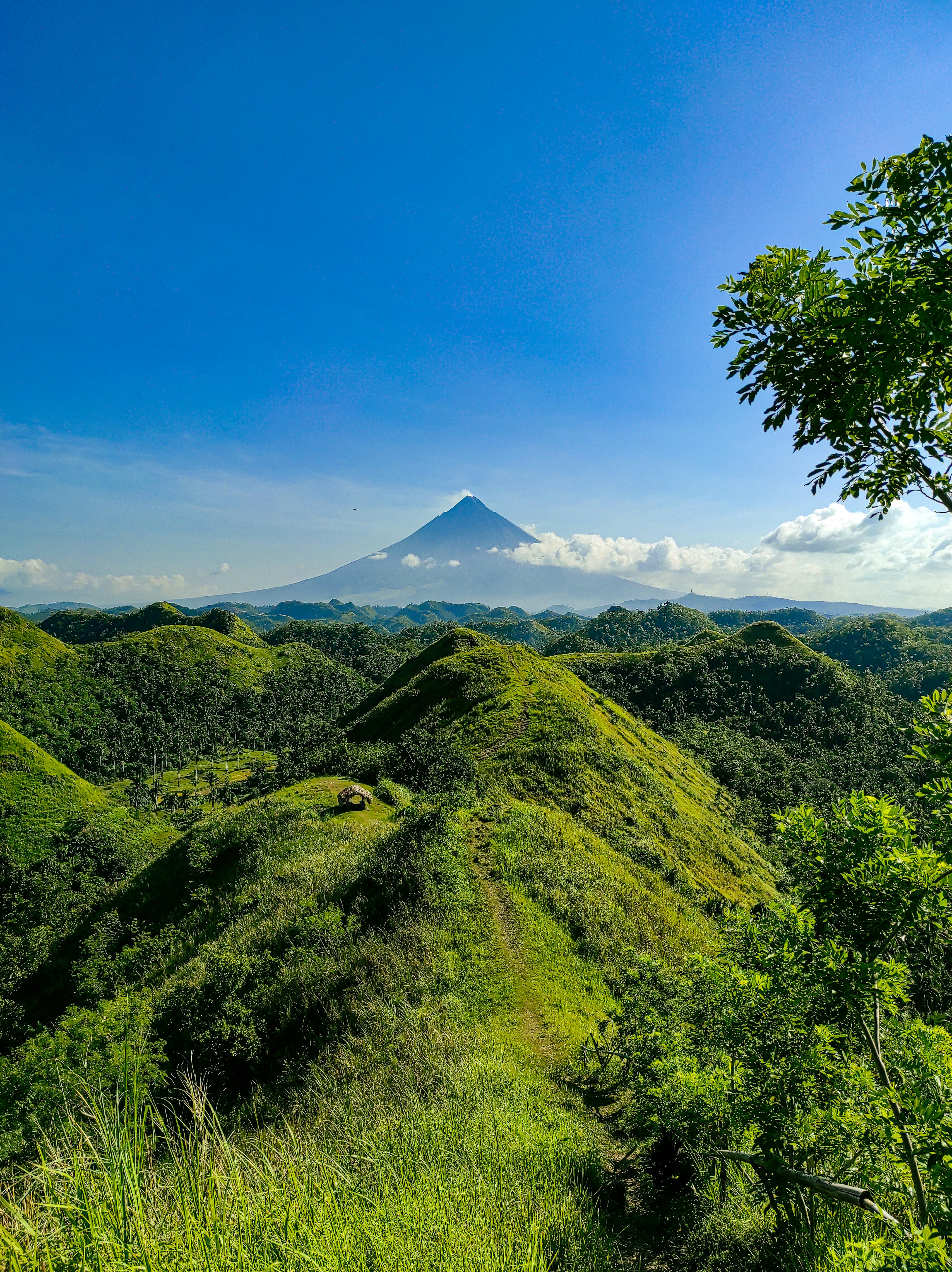 green hills under blue sky