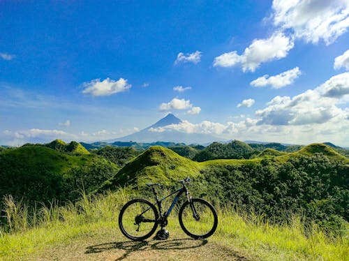 Photo of a Black Bicycle Parked Near Green Hills