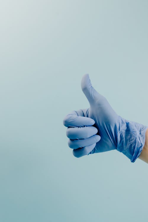 Fotos de stock gratuitas de guantes quirurgicos, mano, pulgares arriba