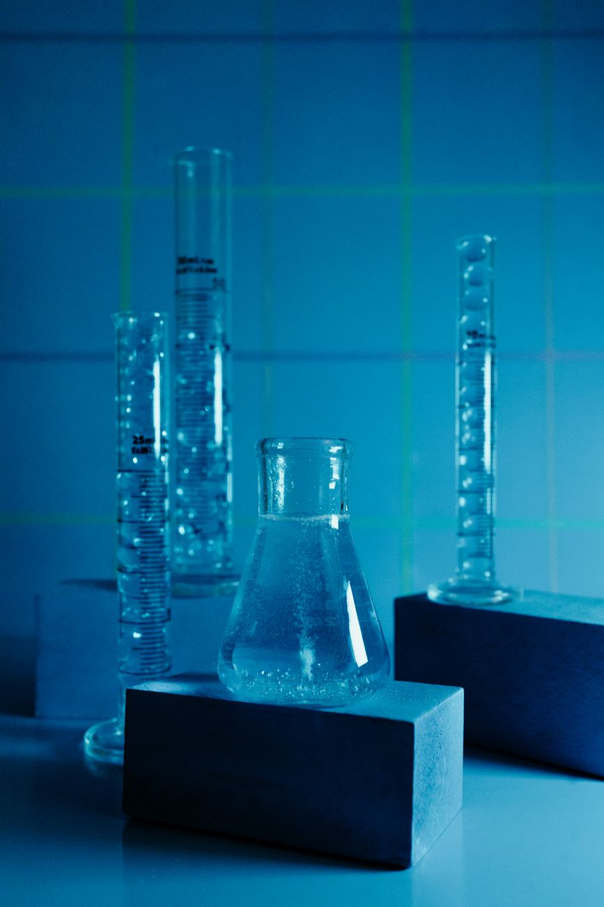 Blue laboratory glassware representing the mechanistic research that links incretin signalling to vascular and kidney effects.