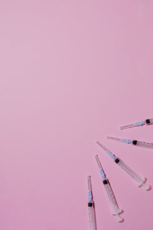  Plastic Syringes On Purple Background