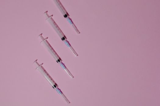 Clear Plastic Syringes on Purple Surface