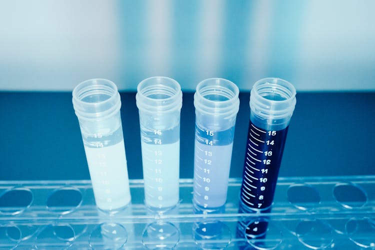 Clear Plastic Vials With Blue And Clear Liquid 