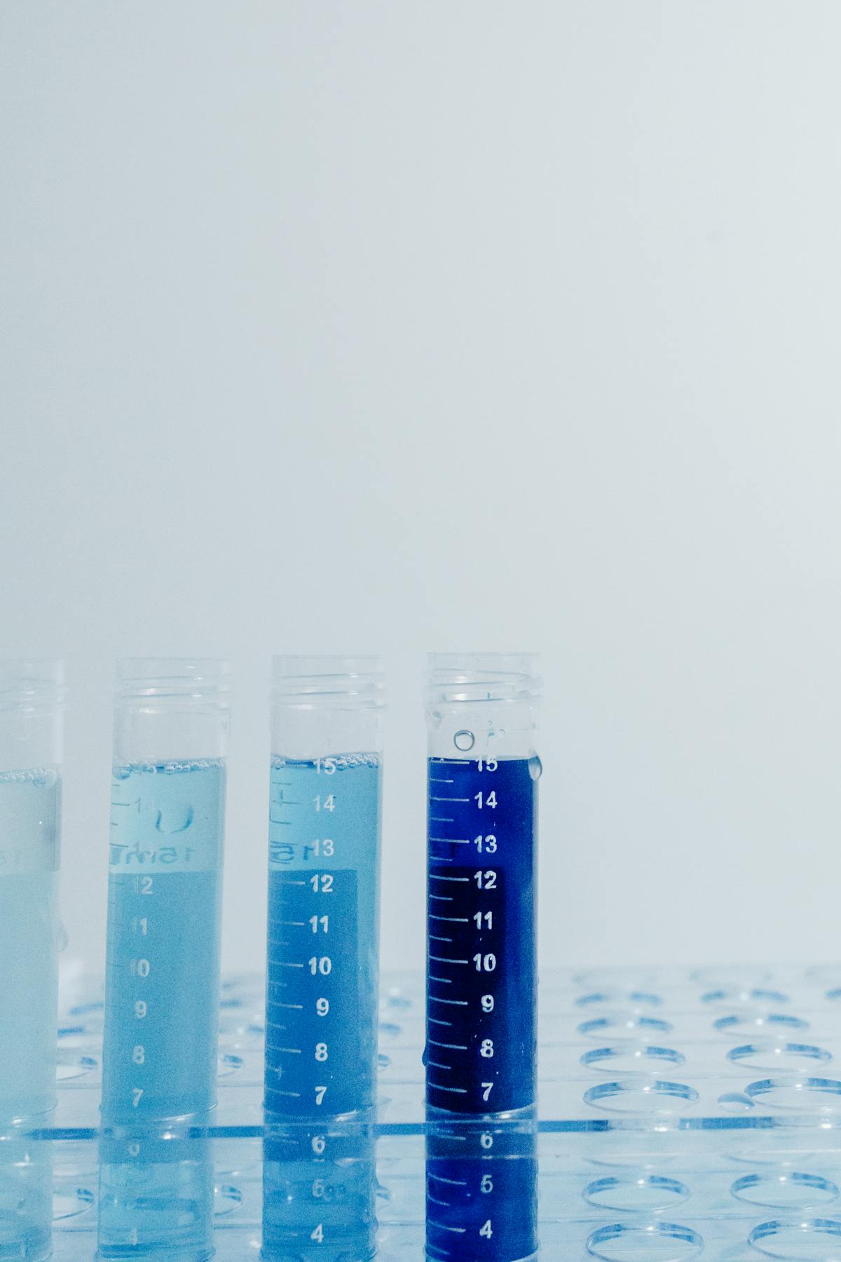 Clear plastic vials with blue liquid