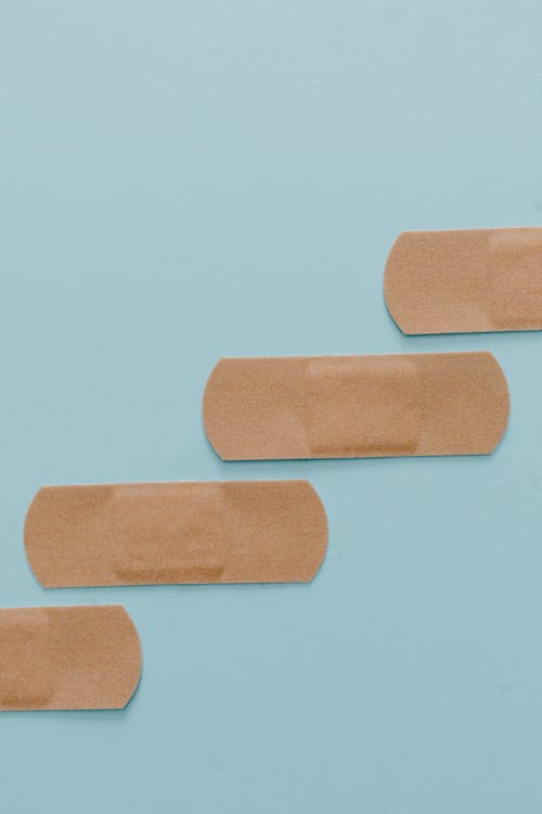 Free Brown Band Aids on Blue Surface Stock Photo