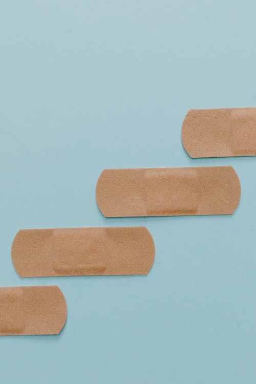 Brown Band Aids on Blue Surface