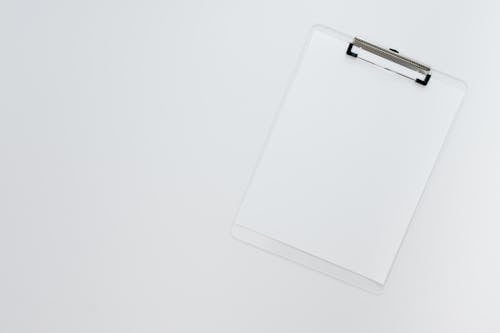 Free A White Sheet of Paper on a Clipboard Stock Photo