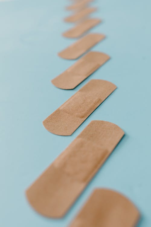 Close Up View of Band Aids On Blue Surface