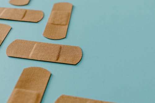 Free Brown Band Aids On Blue Surface Stock Photo