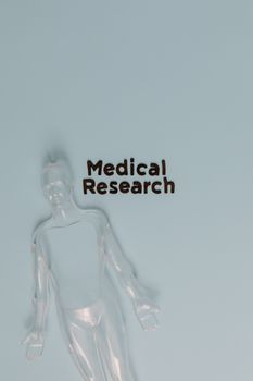 Abstract human sculpture with 'Medical Research' text on a light blue background.