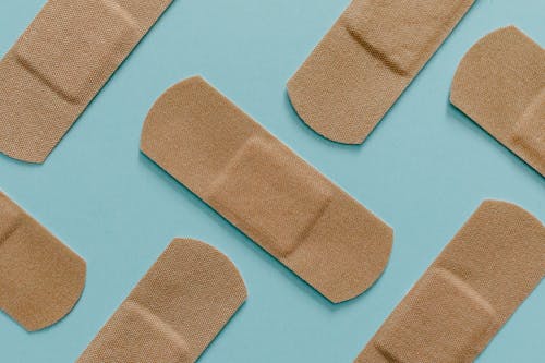 Close Up View Of Band Aids On Blue Surface