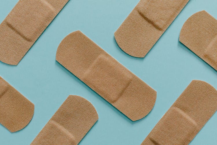 Close Up View Of Band Aids On Blue Surface