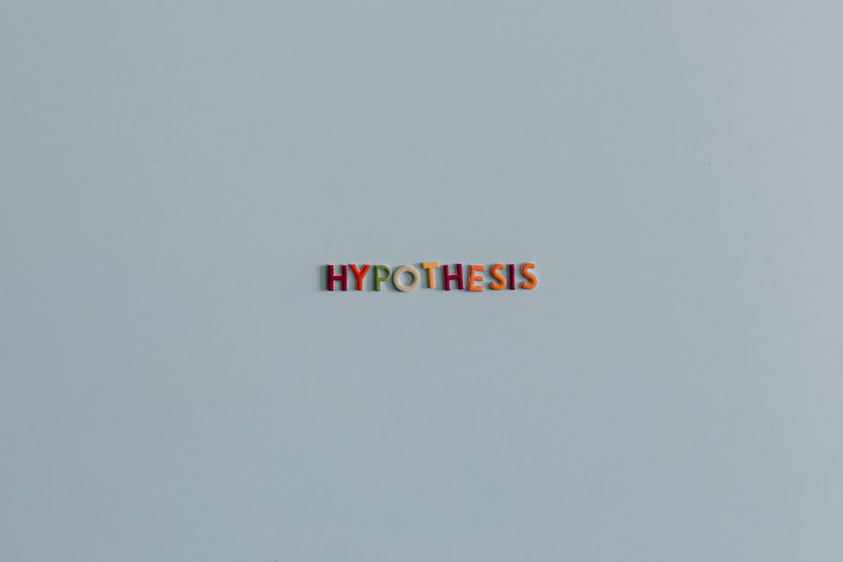 Minimalist image with colorful letters spelling 'Hypothesis' on a light background.