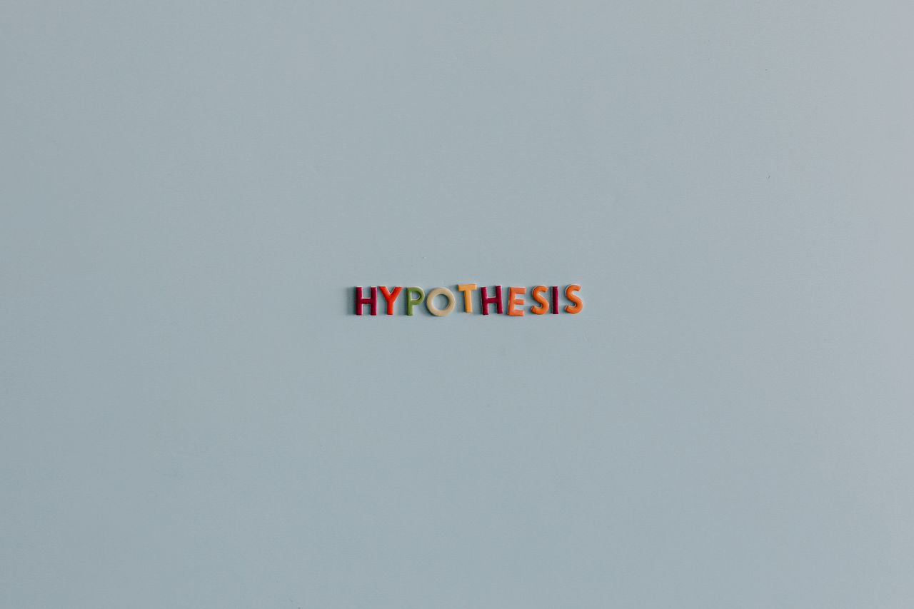minimalist image with colorful letters spelling hypothesis on a light